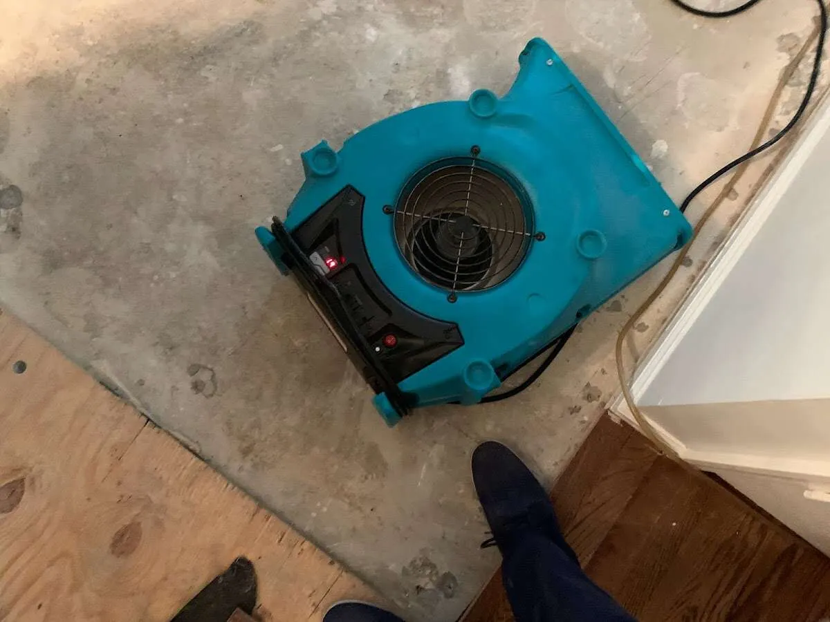 Air mover drying subfloor during Commercial Water Damage Restoration in Channelview